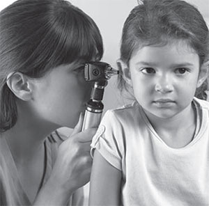 Girl having ear exam