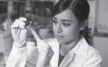 Scientst examining tube