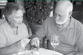 A man and woman eating dinner.