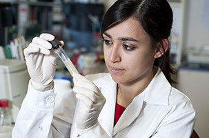 Scientist examining a test tube