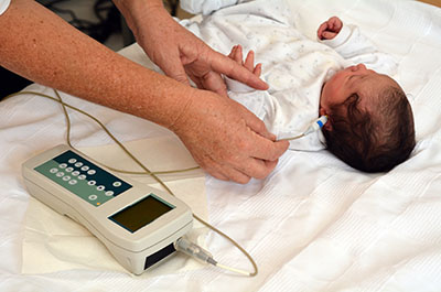 Baby asleep while getting a hearing screening