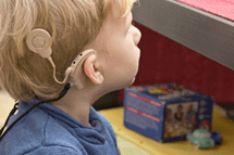 A child wearing a hearing aid.